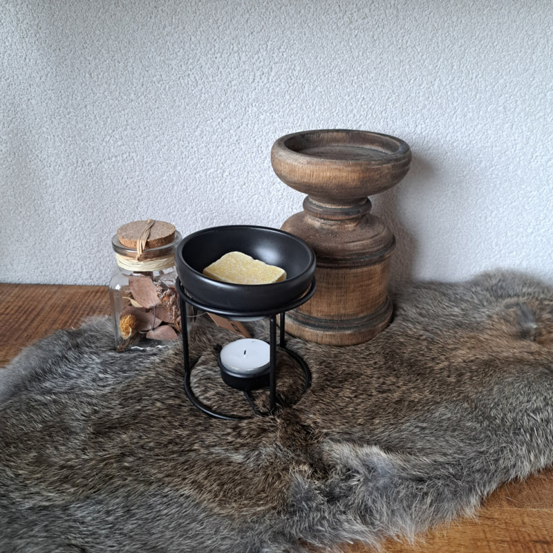 Een elegante zwarte amber blokjes brander met aardewerk schaaltje en metalen houder.
