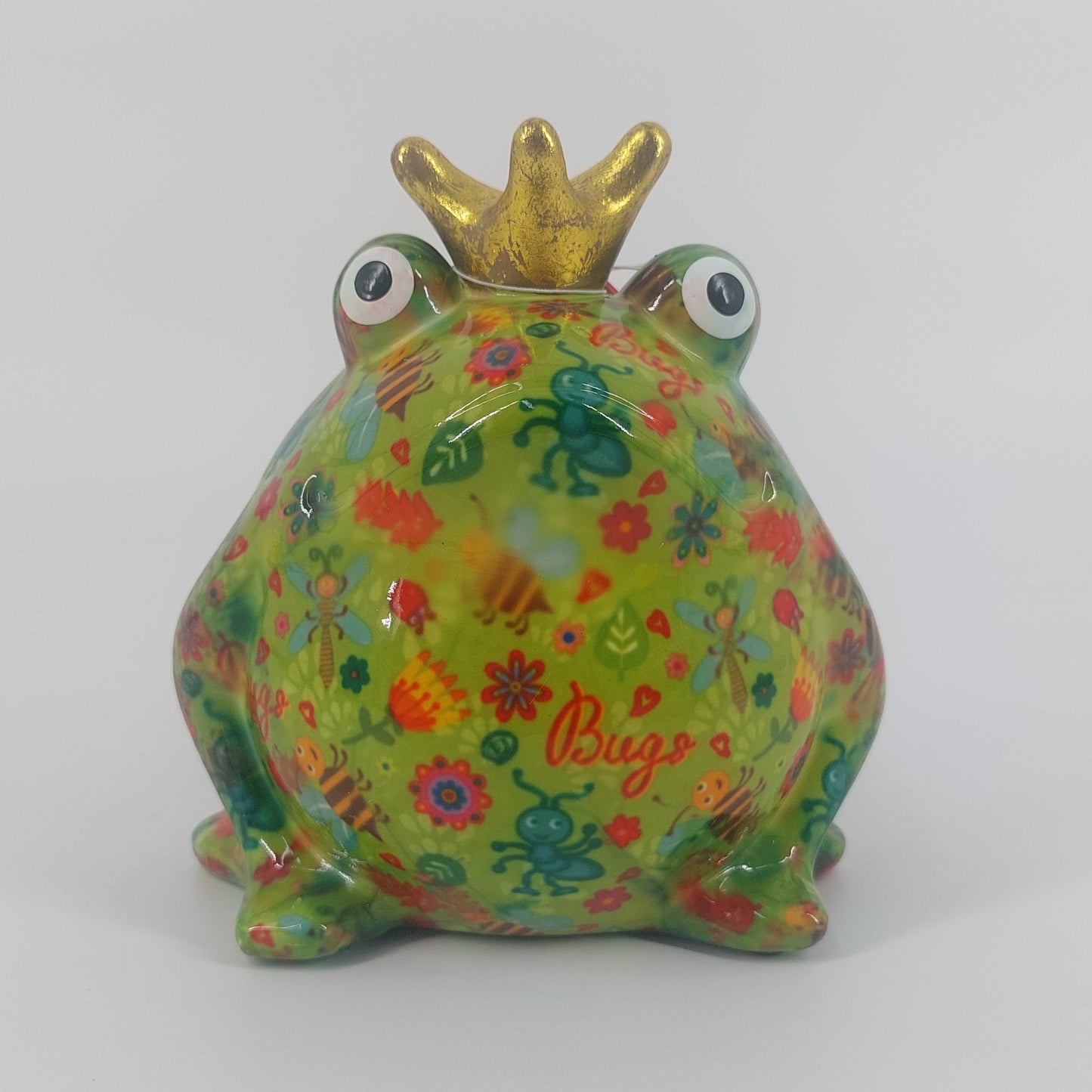 Een vrolijke keramieken spaarpot in de vorm van een kikker, Freddy. Met zijn groene kleur en speelse insectenmotief brengt hij een unieke charme in elke ruimte. Ideaal als decoratie én om geld in te sparen.