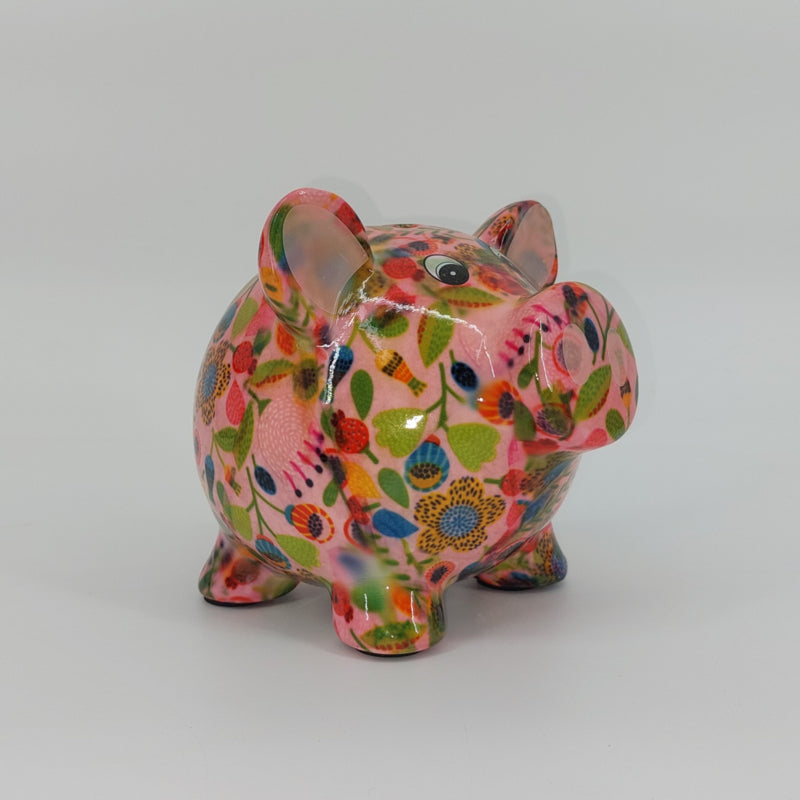 Keramische Pomme Pidou spaarpot in de vorm van een varken, roze met speelse figuurtjes. Afmetingen: L16.5 x B13.5 x H14.1 cm. Een vrolijk en origineel cadeau-idee."